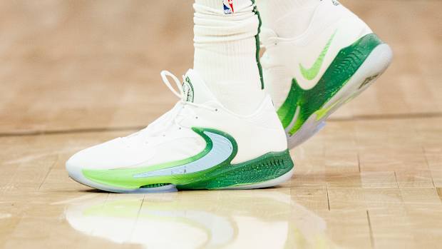 View of Giannis Antetokounmpo's white and green Nike shoes.